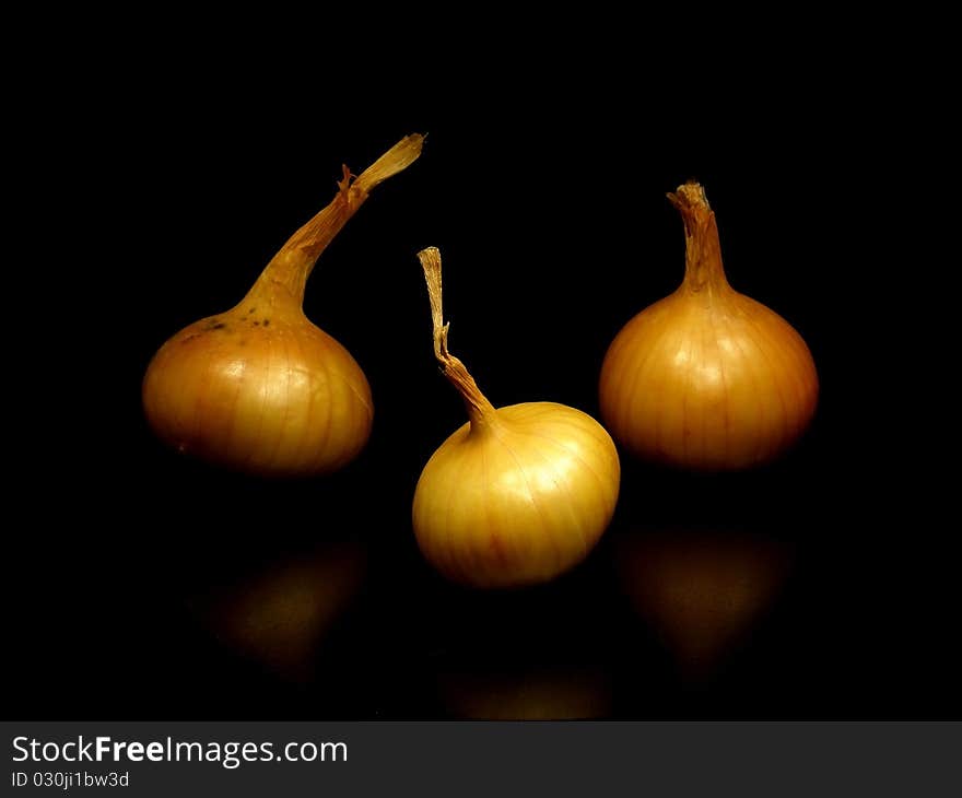 Bulbs of onion on the black background