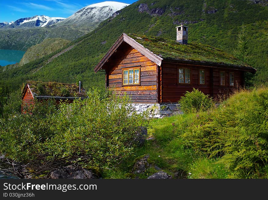 On the photo: Autumn Norway landscape with hut