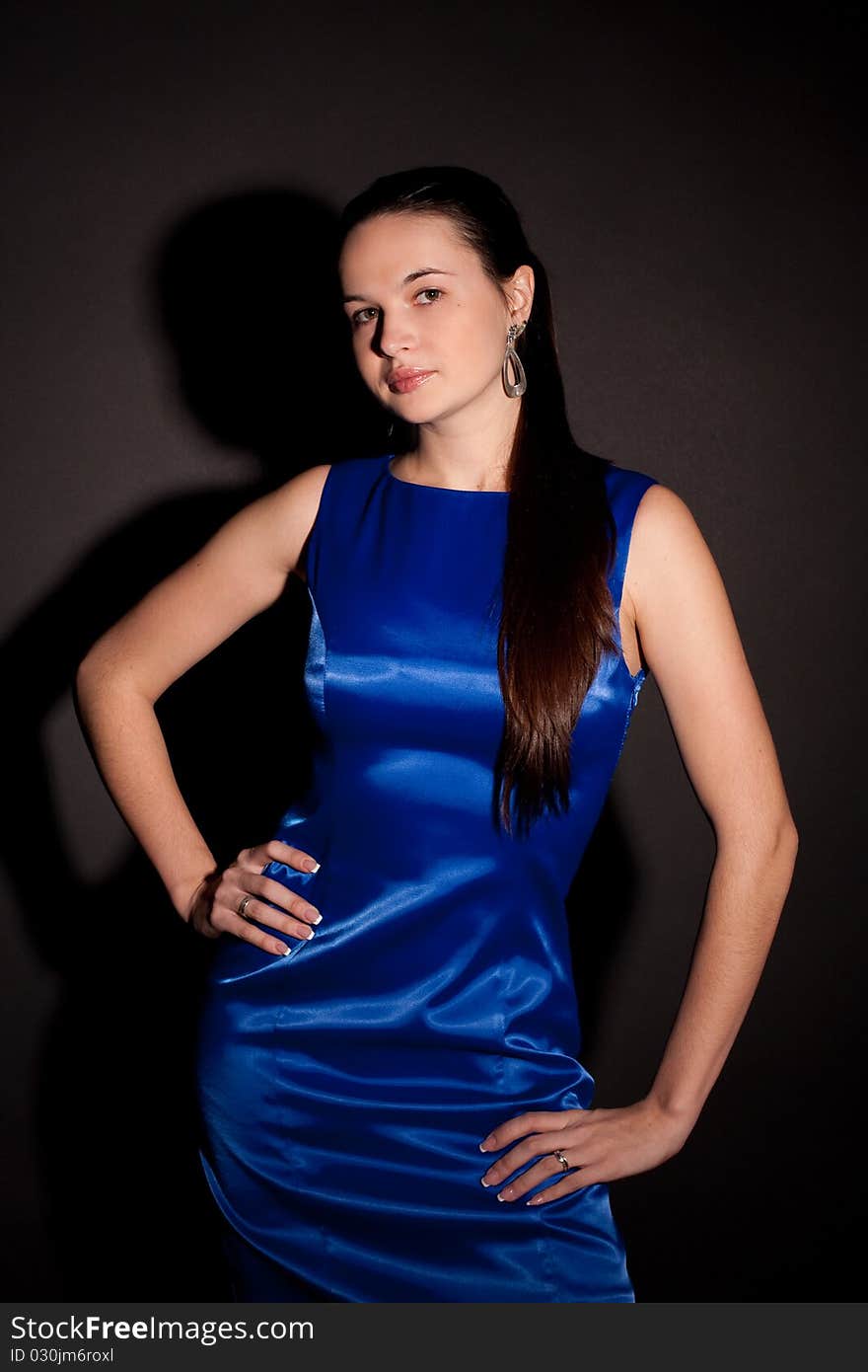 woman in blue dress on black background