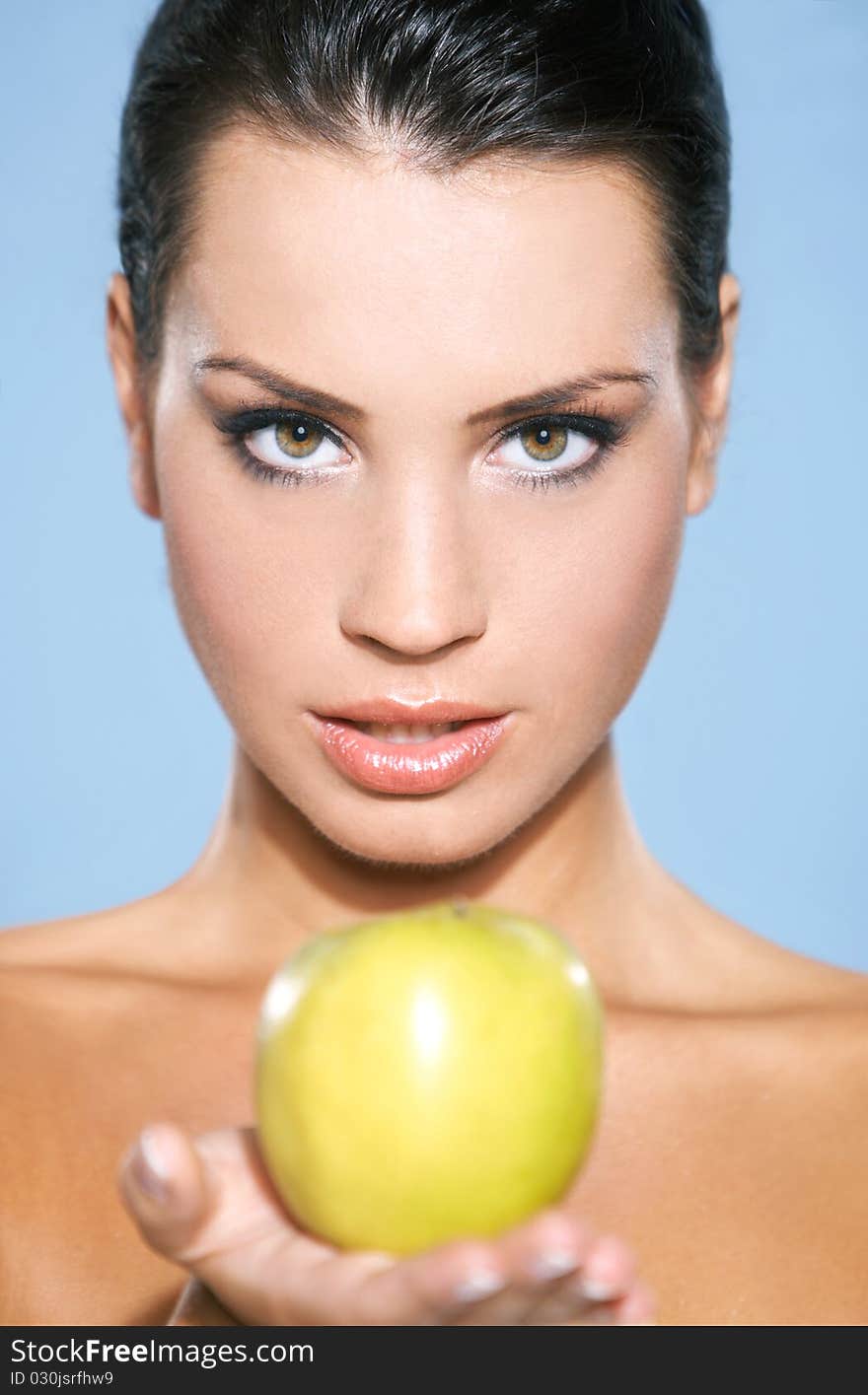 Portrait of beautiful woman, she holding green apple, isolated on blue. Portrait of beautiful woman, she holding green apple, isolated on blue