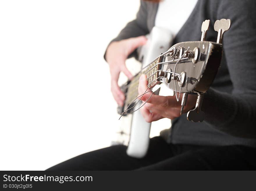 Playing electrical bass guitar isolated on white