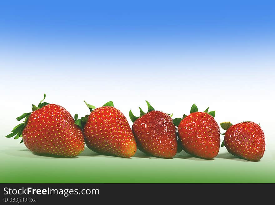 And ripe red strawberries on a colored background