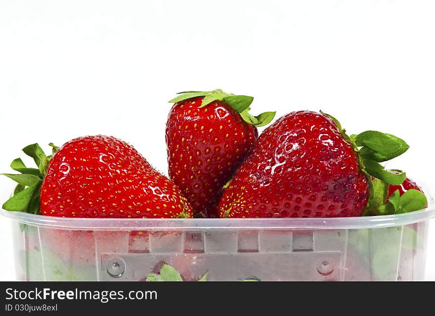 Strawberries in the trash is plastic on a white background