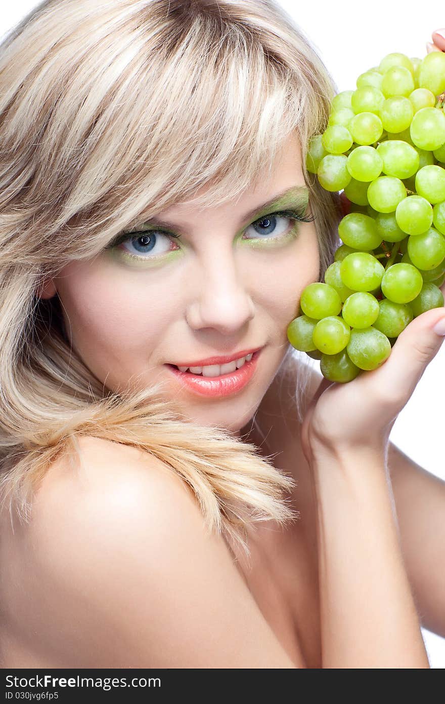 Beautiful woman over white background with grape. Beautiful woman over white background with grape