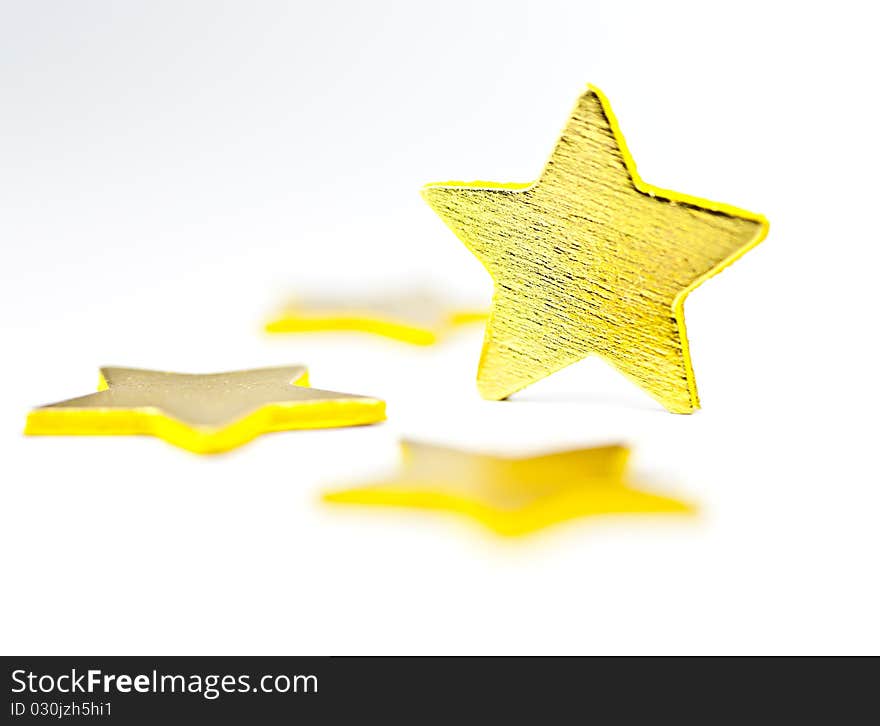 On a white background golden stars, one star in a vertical position. On a white background golden stars, one star in a vertical position.