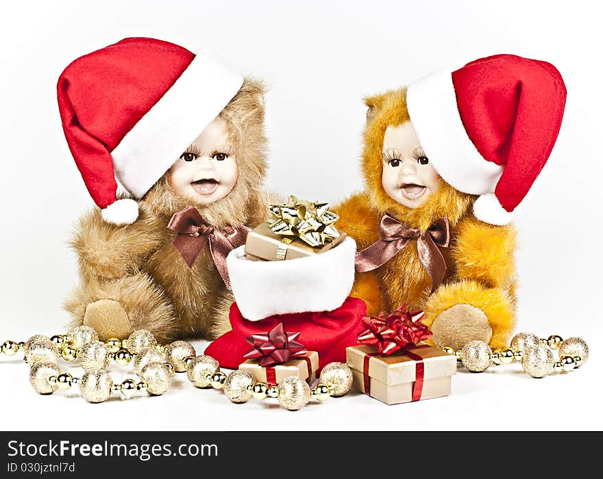 On a white background are two porcelain bears a Christmas gift bag and a golden ball strings. On a white background are two porcelain bears a Christmas gift bag and a golden ball strings.