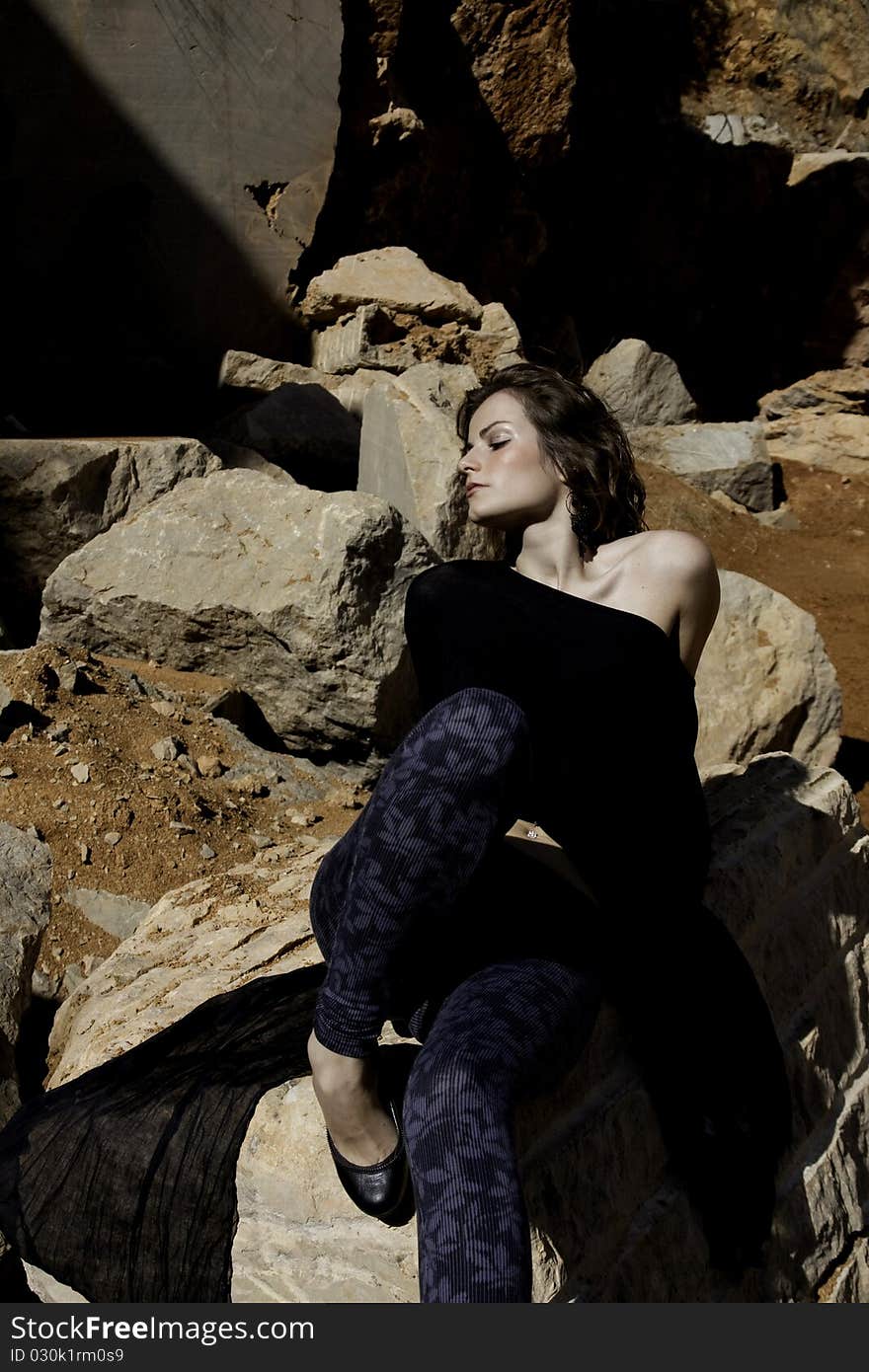 Woman poses on a stone quarry