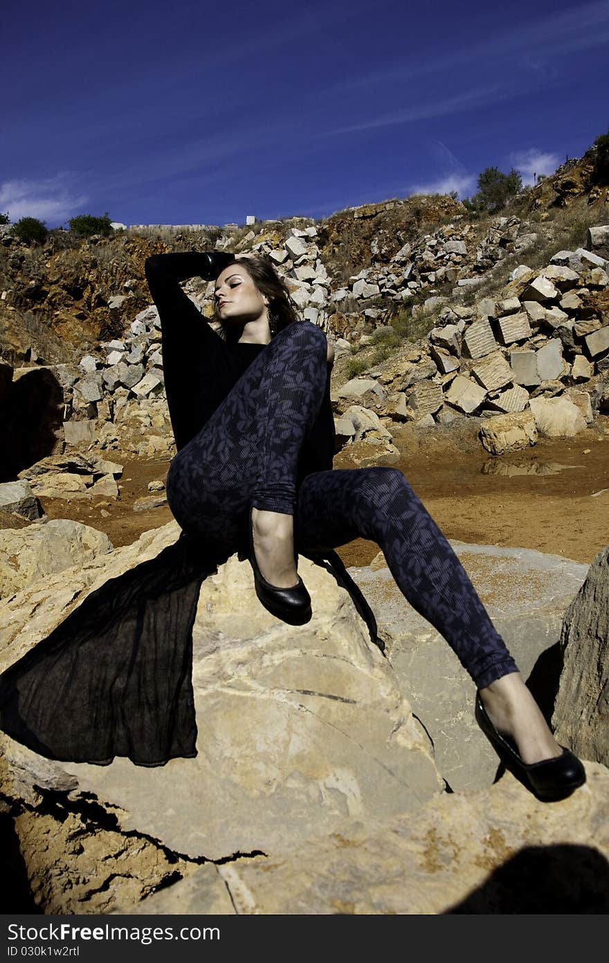 Woman poses on a stone quarry