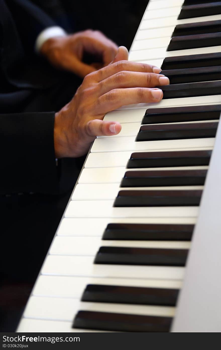 Hands of musician playing the piano - close up. Hands of musician playing the piano - close up