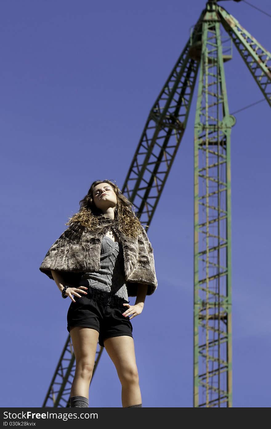 View of a beautiful woman posing on a fashion style. View of a beautiful woman posing on a fashion style.