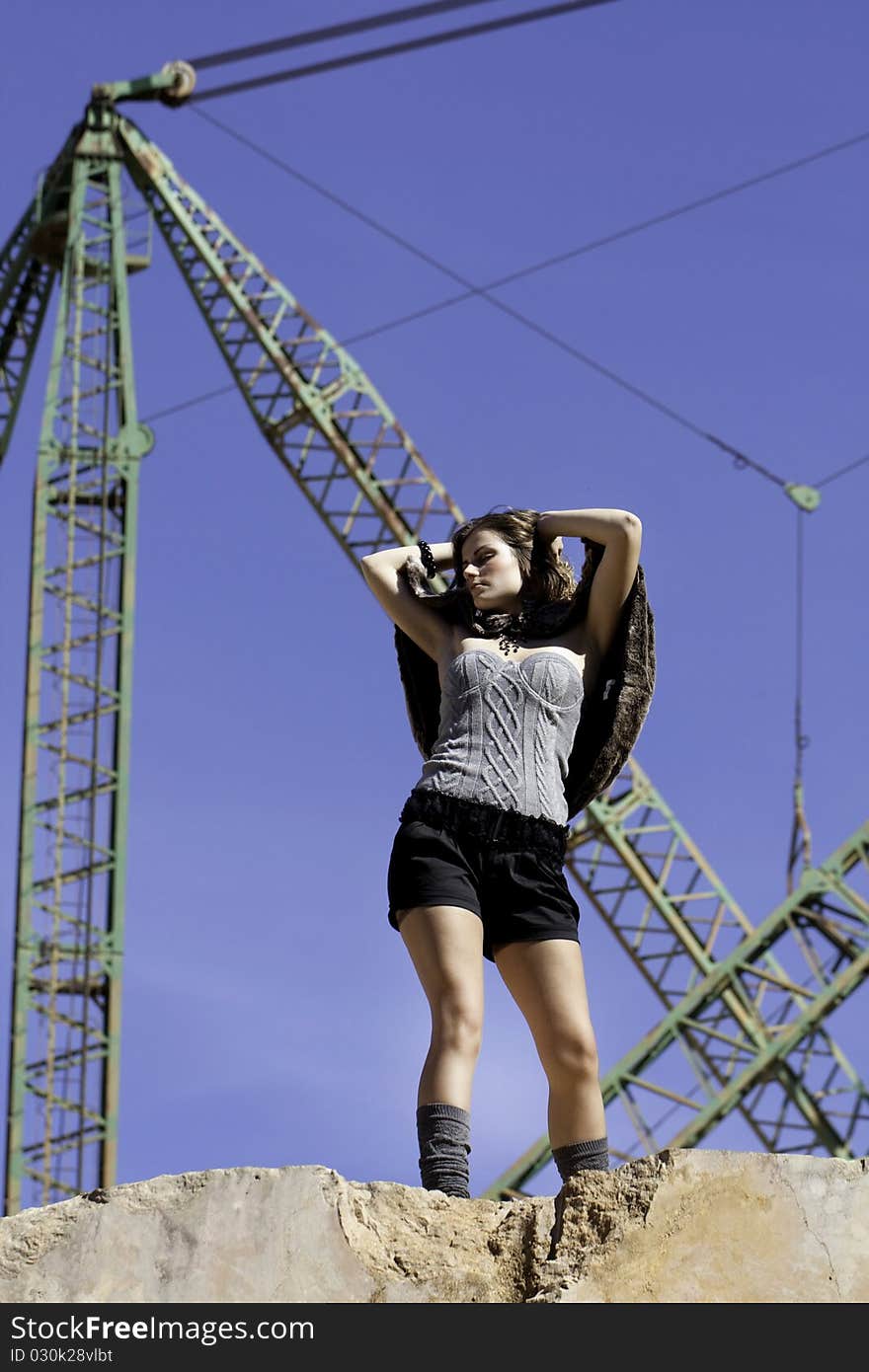 View of a beautiful woman posing on a fashion style. View of a beautiful woman posing on a fashion style.