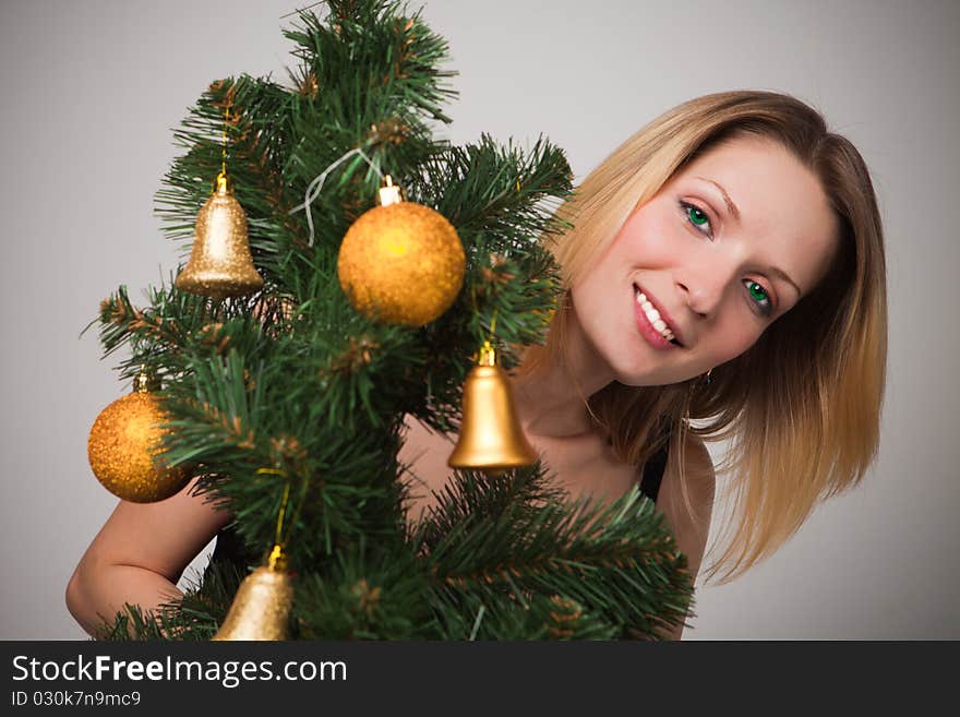 Portrait of a beautiful young woman over christmas three with green eye