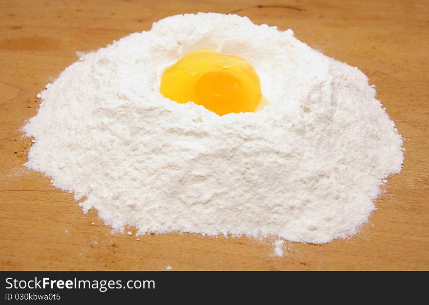 Flour and egg on the board. Flour and egg on the board