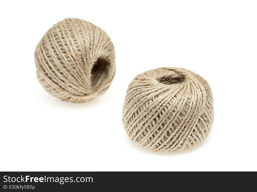 Spools of hemp twine on a white