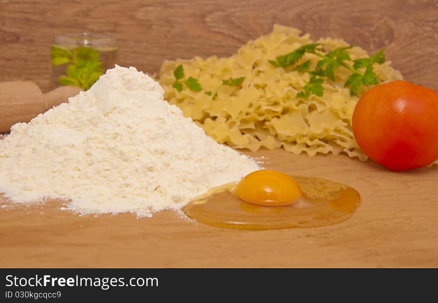 Nice fresh pasta ingredients on a board to knead dough