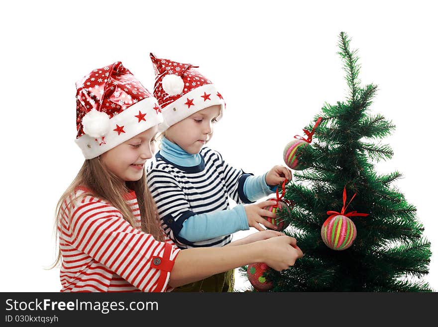 Two little girls decorating a new year tree. Two little girls decorating a new year tree