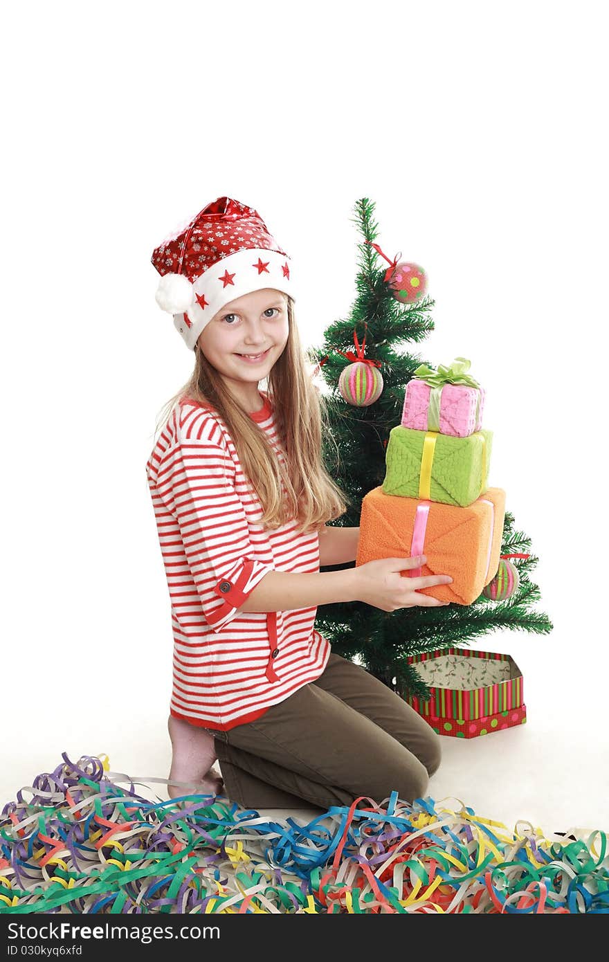 A little girl with three boxes at the tree. A little girl with three boxes at the tree