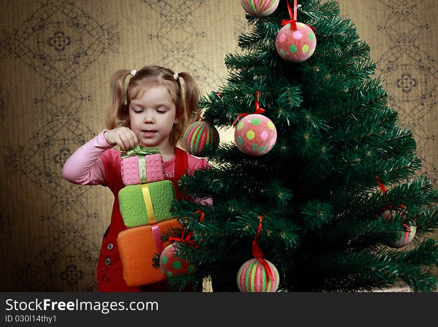 A little girl with three boxes with presents. A little girl with three boxes with presents