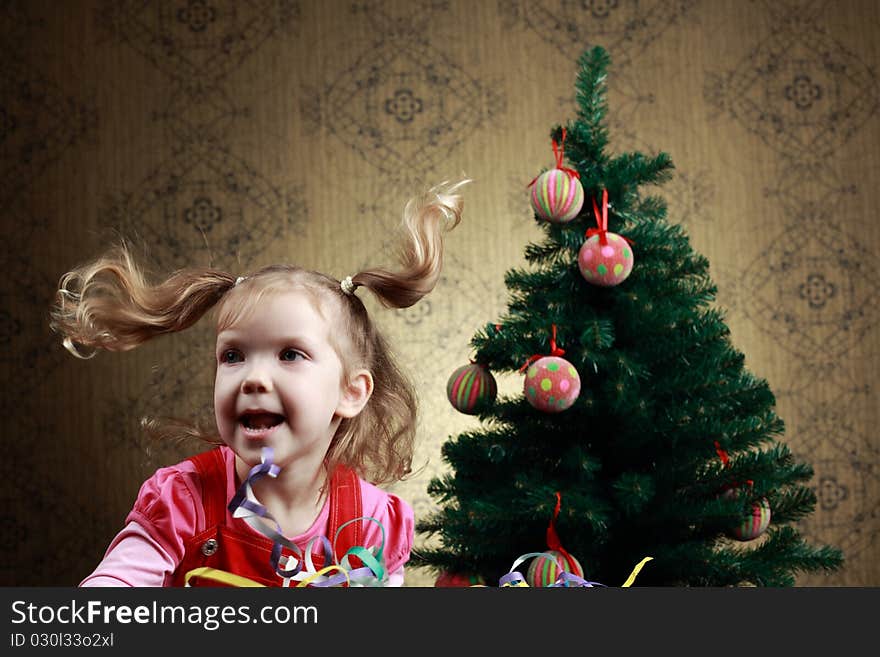 A nice girl jumping at a new year tree. A nice girl jumping at a new year tree