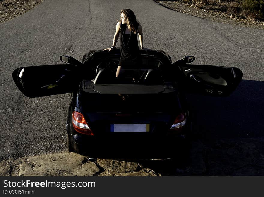 View of a beautiful woman inside a sports car. View of a beautiful woman inside a sports car.