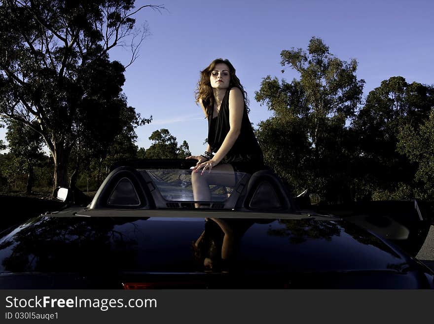 View of a beautiful woman inside a sports car. View of a beautiful woman inside a sports car.