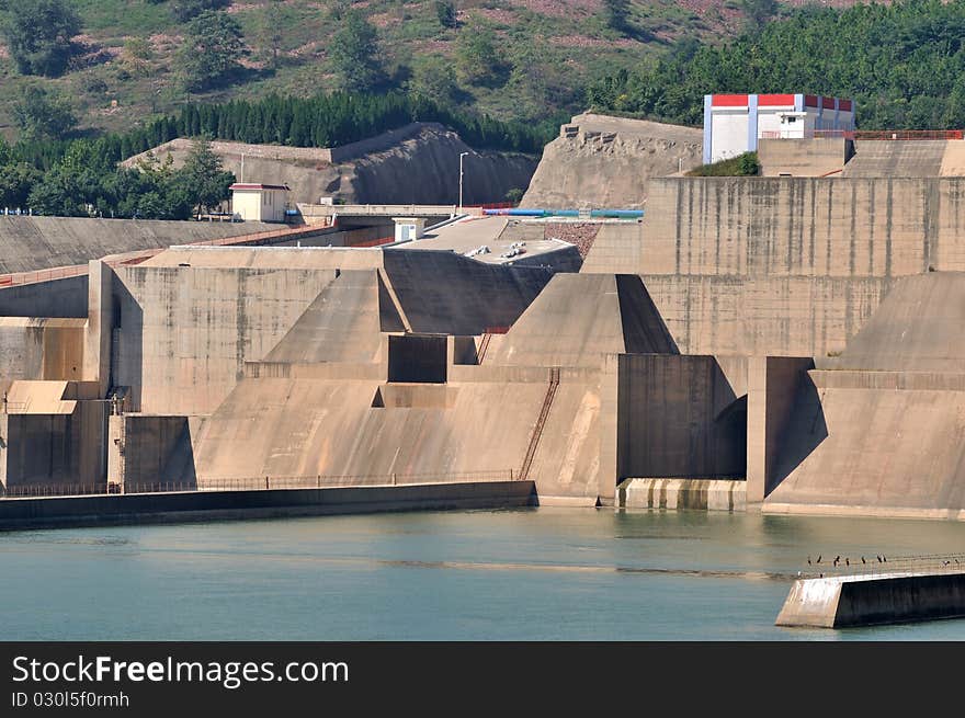 Water electricity plant, as big construction made by concrete built beside river, composed by plant buildings and water dam. Water electricity plant, as big construction made by concrete built beside river, composed by plant buildings and water dam.