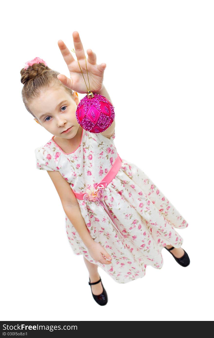 High angle view of a little cute girl playing with a tree-decoration ball. High angle view of a little cute girl playing with a tree-decoration ball