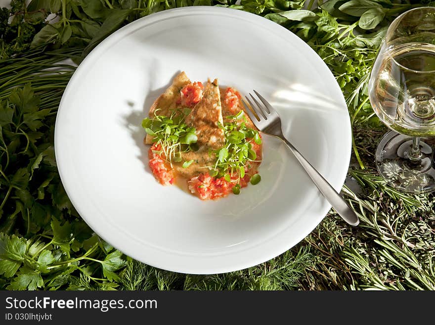 Paprika vinaigrete on a white plate with white wine.