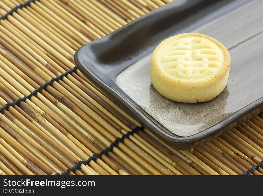 Delicious chinese cake for tea time snack on rectangular plate. Delicious chinese cake for tea time snack on rectangular plate