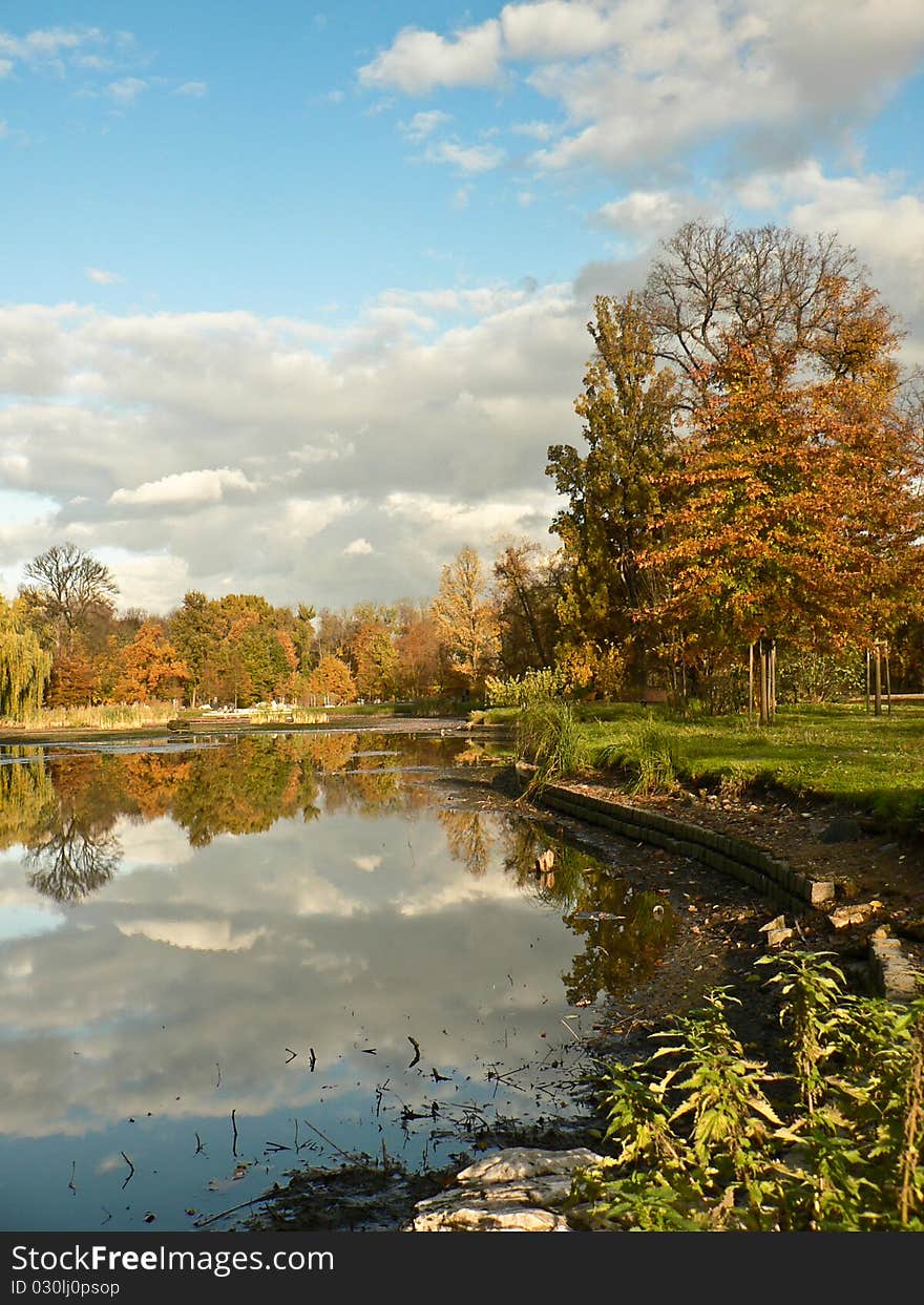 Colorful fall park with pond