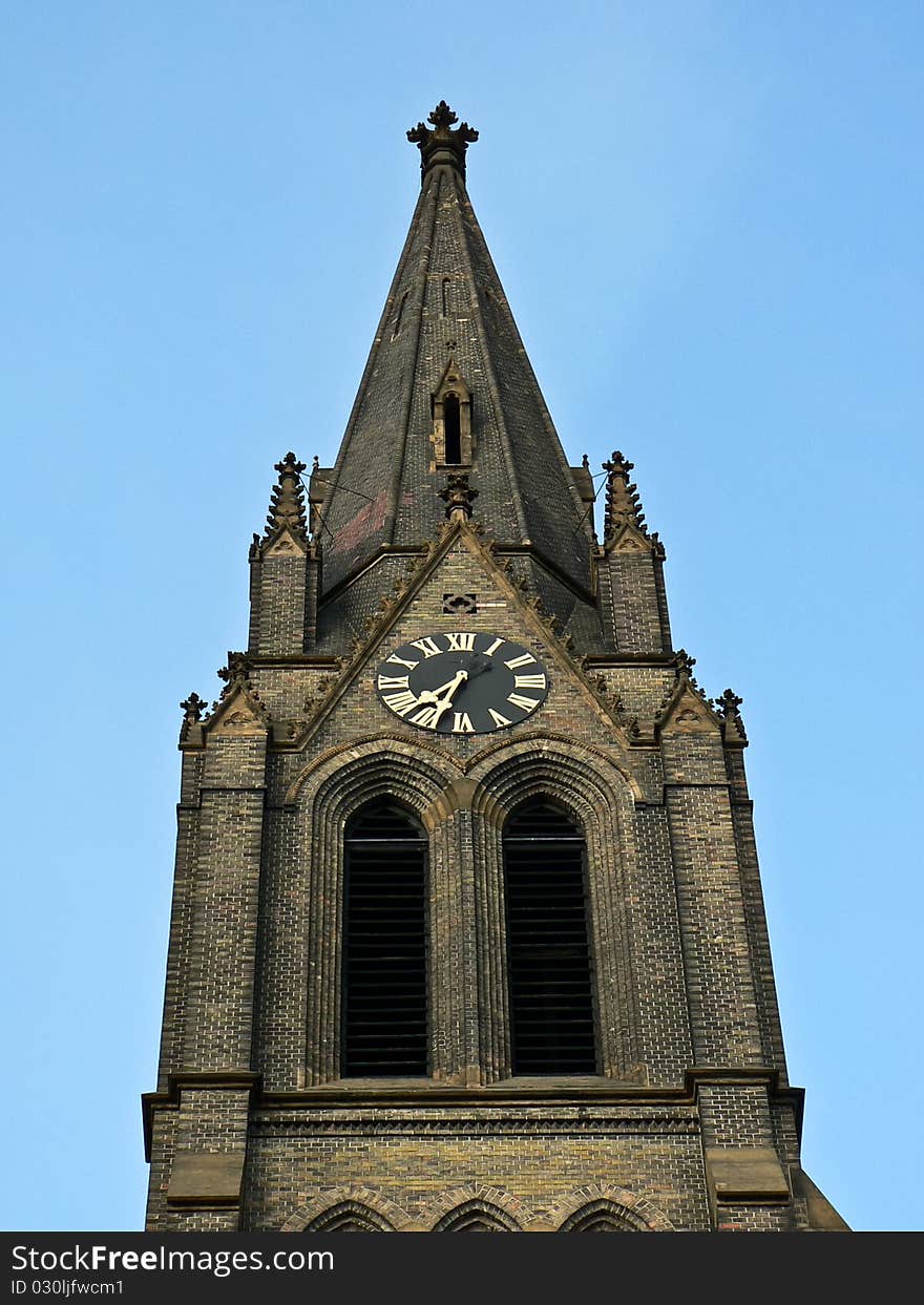 Neogothic steeple with blue sky in background