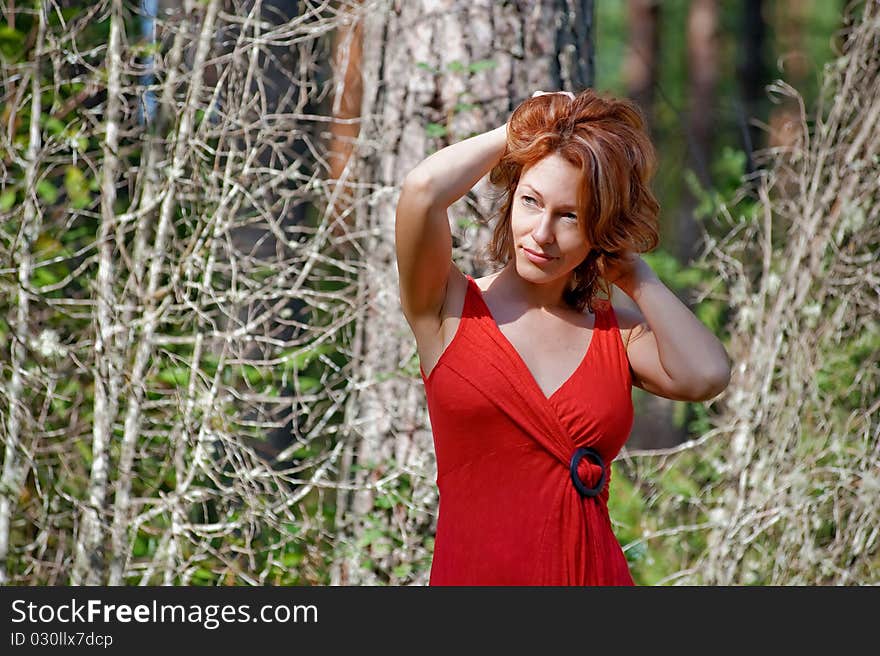 Portrait of red-haired adult woman in nature. Portrait of red-haired adult woman in nature