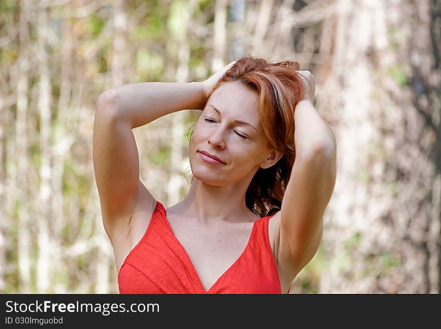 Portrait of red-haired adult woman in nature. Portrait of red-haired adult woman in nature