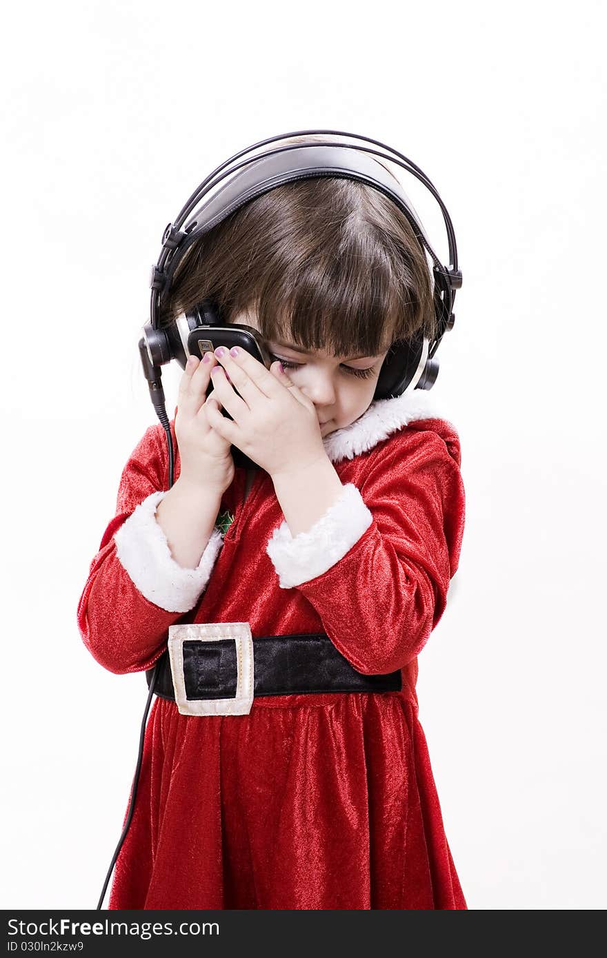 Christmas child with sell phone and headphones. Christmas child with sell phone and headphones