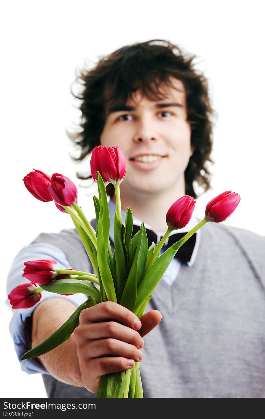 A young boy with a bouquet of red tulips. A young boy with a bouquet of red tulips