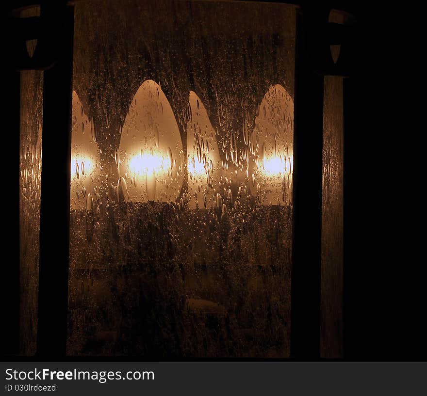 A lit lamp having glass texture resembling rain drops. A lit lamp having glass texture resembling rain drops