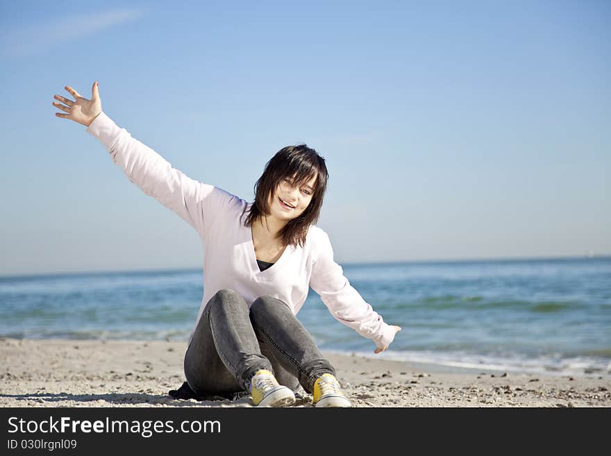 Portrait of brunette girl at the beach. Outdoor shot.