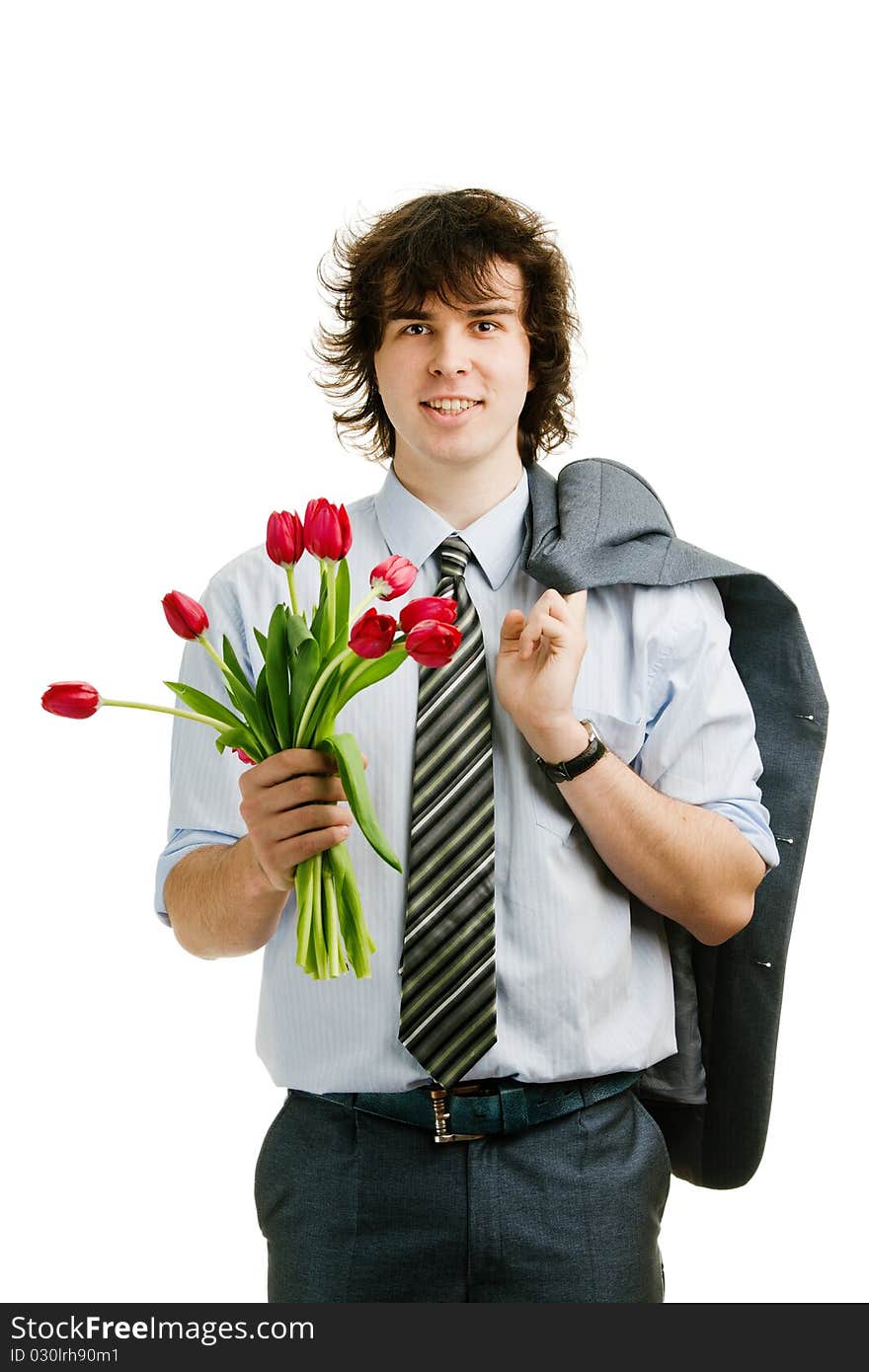 An image of a young cheerful man with red tulips. An image of a young cheerful man with red tulips