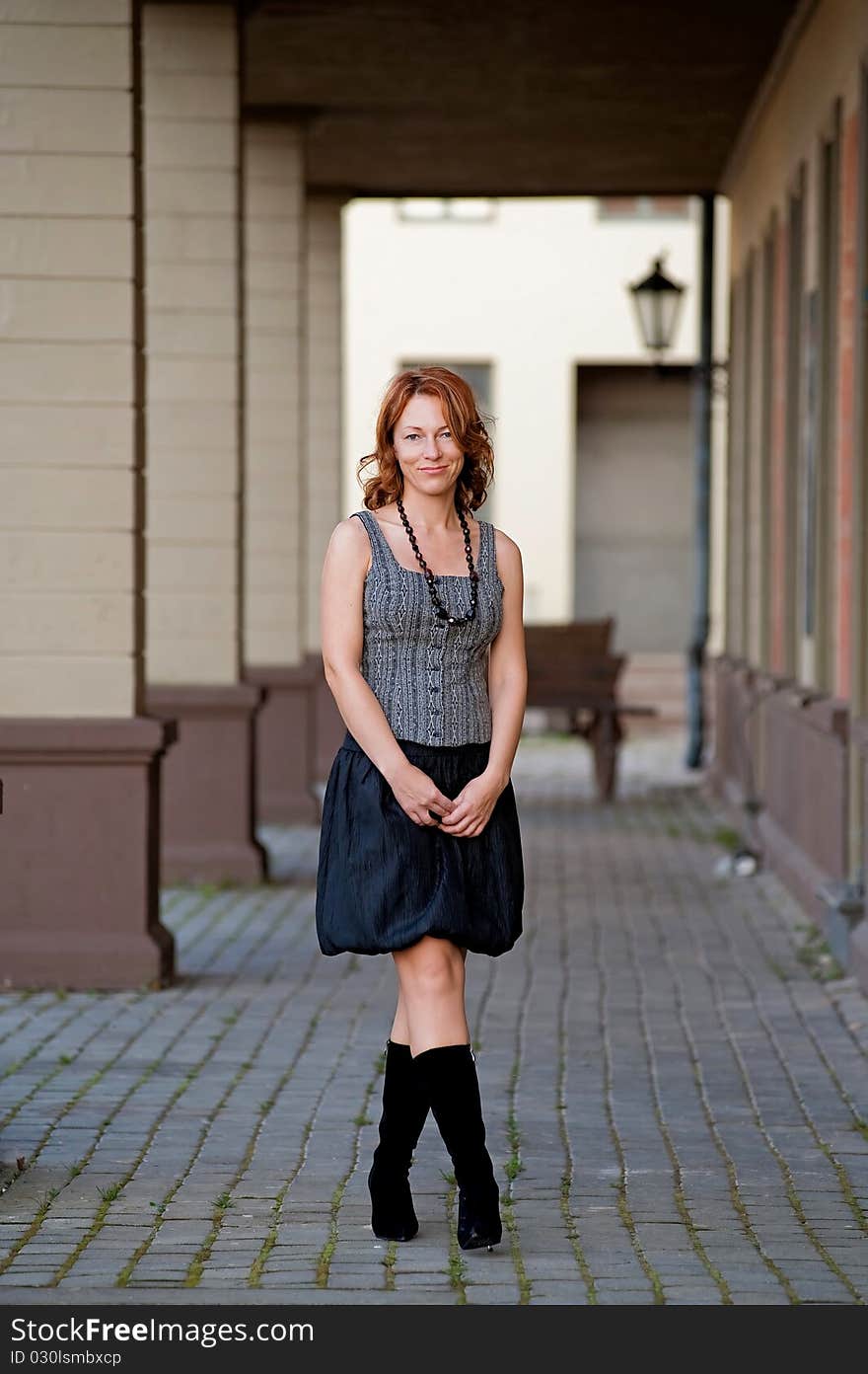 Beauty Woman On The Pavement Street.