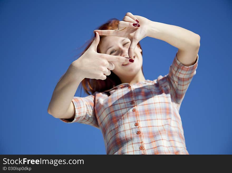 Girl at blue background show frame.