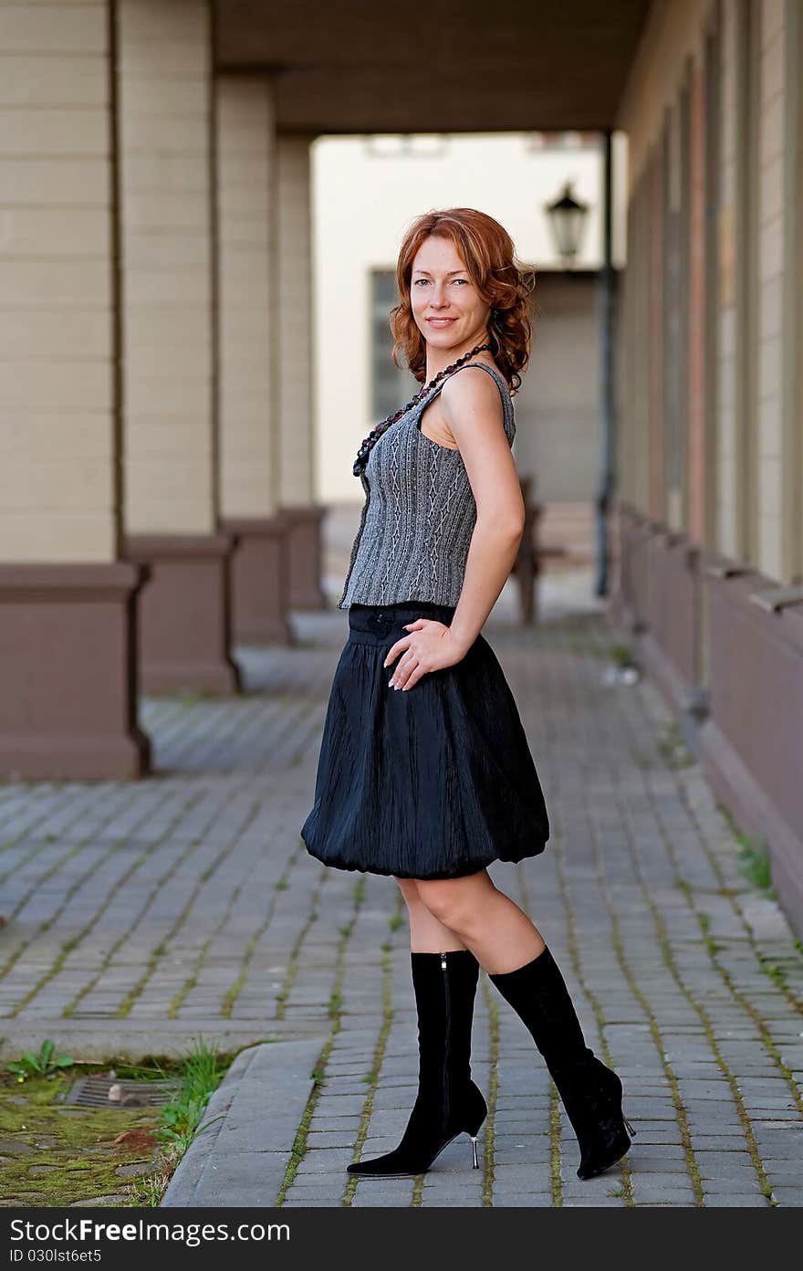 Mature, beautiful woman posing on the pavement street near arc. Mature, beautiful woman posing on the pavement street near arc.