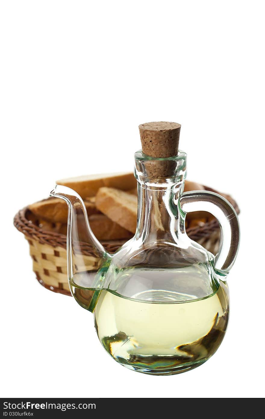 Olive oil in a transparent glass and bread isolated on white