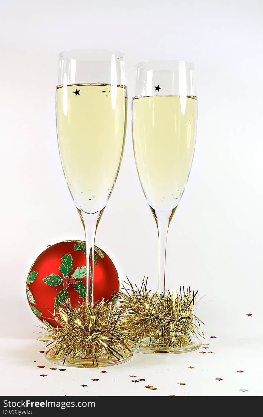 Holiday shampagne and glasses with a christmas ball