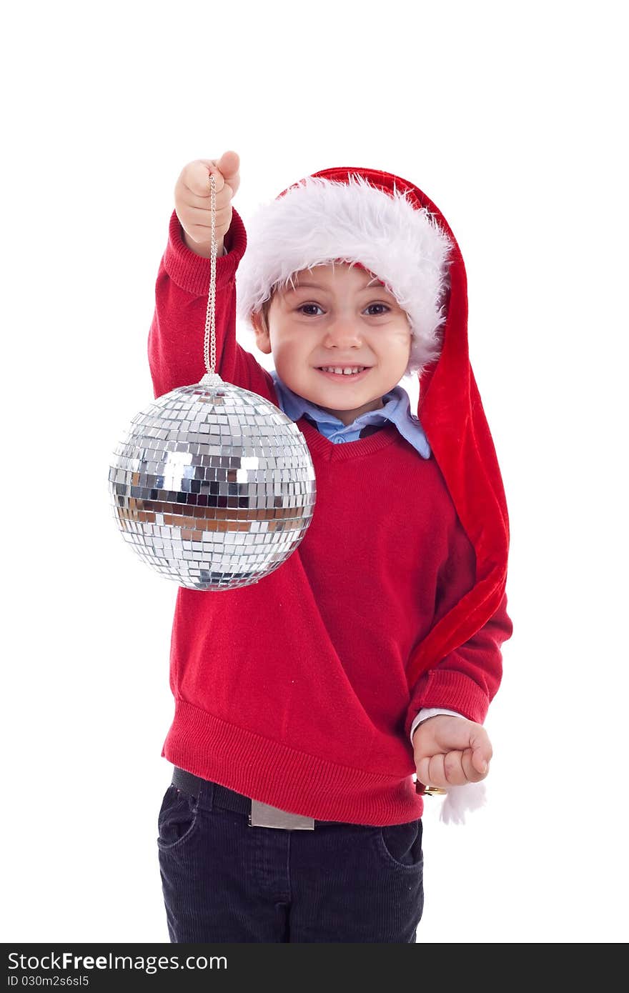 Small boy in Santa's red hat holding a glass disco ball over white. Small boy in Santa's red hat holding a glass disco ball over white