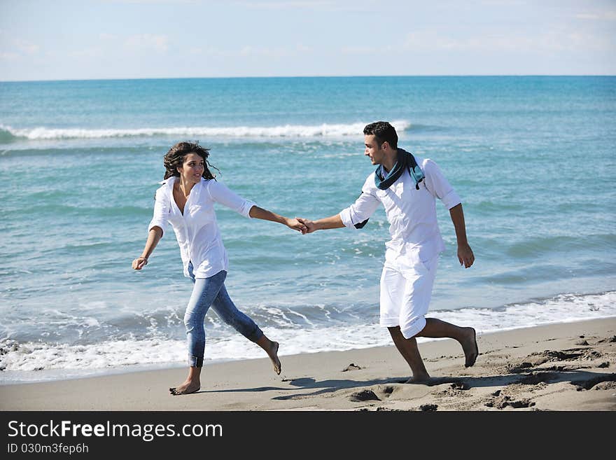 Happy Young Couple Have Fun At Beautiful Beach