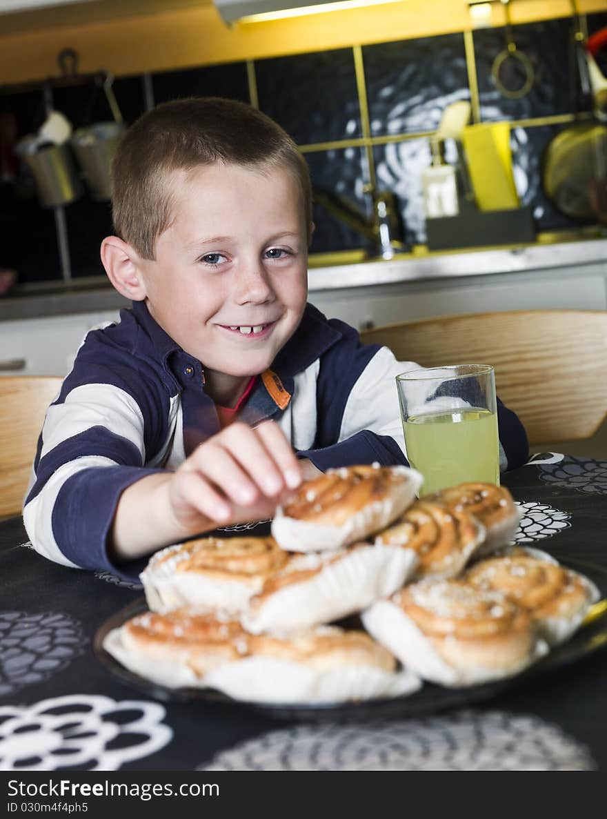 Young Boy reaching for sweets in the kitchen. Young Boy reaching for sweets in the kitchen