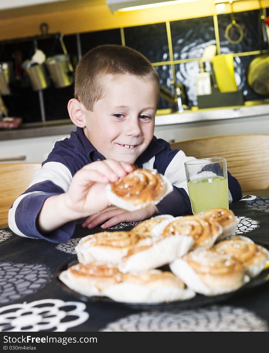 Young Boy reaching for sweets in the kitchen. Young Boy reaching for sweets in the kitchen