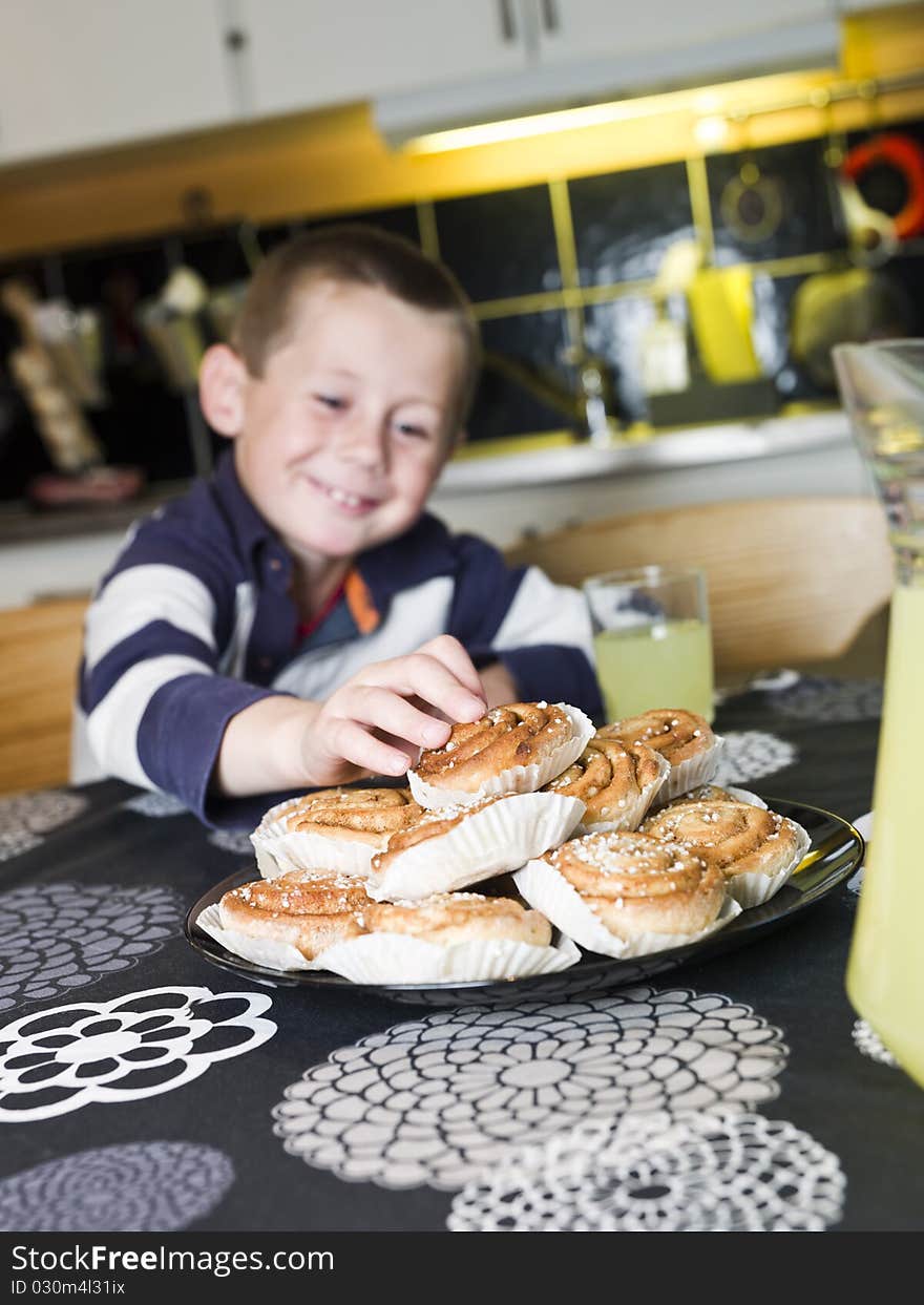 Young Boy reaching for sweets in the kitchen. Young Boy reaching for sweets in the kitchen