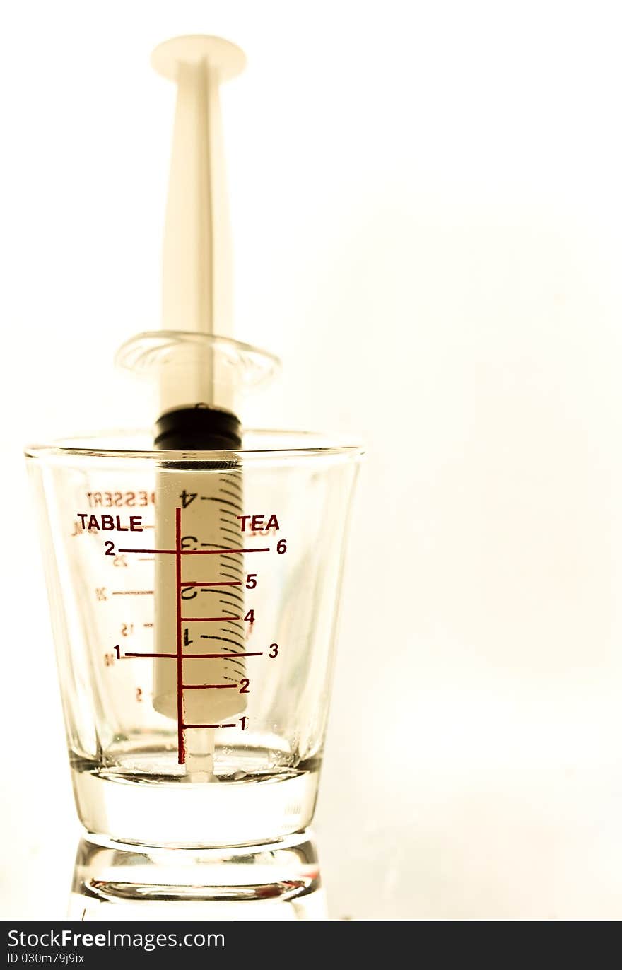 Syringe and medical glass on white background. Syringe and medical glass on white background