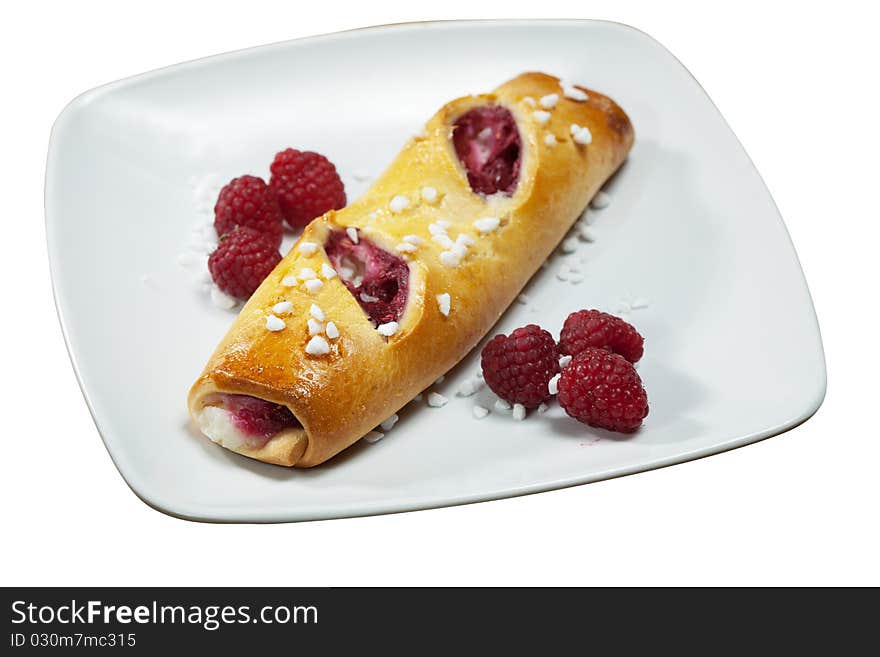 Sweet danish pastry filled with raspberries on white plate isolated. Sweet danish pastry filled with raspberries on white plate isolated